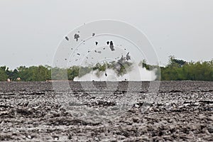 Mud volcano with bursting bubble bledug kuwu. volcanic plateau with geothermal activity and geysers, slow motion Indonesia java.
