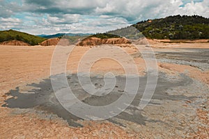 Mud volcano erupting with dirt, vulcanii Noroiosi in Buzau, Romania. Cracks, eruption.