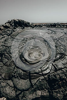Mud volcanoes at Gobustan, Azerbaijan. Landmark area filled with hills made from mud where eruptions are seen. Detail of a mud