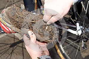 Muddy bicycle shoe after cross-country ride