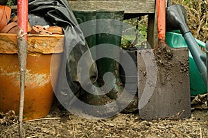 Muddy boots and spade.