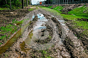 A muddy country road on the edge of the forest in early spring