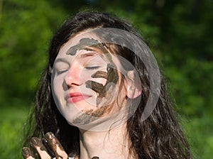 Muddy Face of a Young Woman