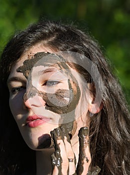 Muddy Face of a Young Woman