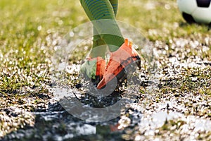 Muddy Football Field. Player Walking On Muddy Soccer Pitch