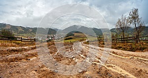 Muddy ground after rain in mountains. Extreme path rural dirt road in the hills