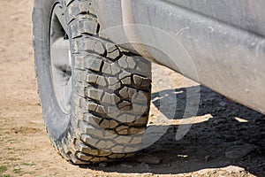 Muddy off-road tire with rough tread for 4x4.