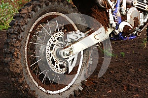 Muddy rear wheel of dirt bike