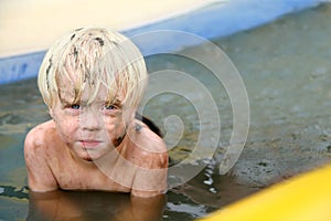 Muddy Toddler Boy Outside in Baby Swimming Pool