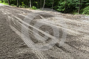 Muddy Tracks on a Dirt Road During Repairs