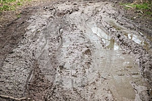 Muddy trail with tire tracks next to River Cole in England
