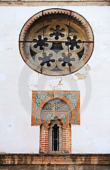 Mudejar style window with tiles -alicatados-  and rose window of the church of Omnium Sanctorum in Seville, Spain photo