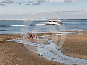 Mudflat hiking and ferry in WittdÃÂ¼n channel, Amrum island, North Frisia, Schleswig-Holstein, Germany