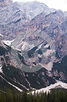 Mudflow with snow high in the Alpine mountains lake, Lago Di Braies photo