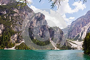 Mudflow with snow high in the Alpine mountains lake, Lago Di Braies photo