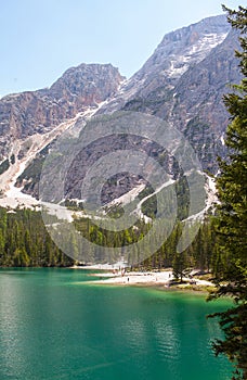 Mudflow with snow high in the Alpine mountains lake, Lago Di Braies photo