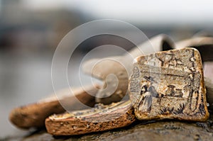 Mudlarking on the River Thames: Close up of a detailed piece of old broken pottery found along a river