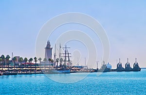 Muelle Uno and La Farola lighthouse, Malaga Port, Spain photo