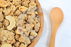 Muesli in bamboo bowl with wooden spoon