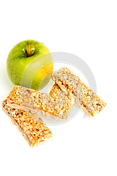 Muesli bars dried fruit on isolated background with apple
