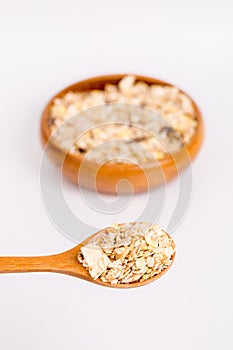 Muesli in bowl and wooden spoon