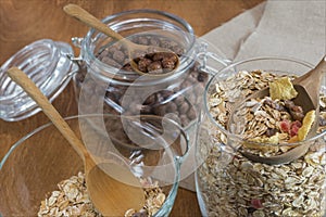 Muesli, Breakfast cereal, cereal and rice in a glass container on a wooden table. Rustic food.