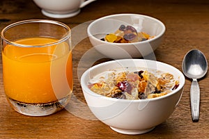 Muesli cereal breakfast with milk and preserved tropical fruit