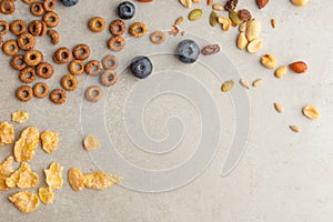 Muesli and cereals are scattered with jars of blueberries and sweet cookies on a light background, breakfast background.flat lay?