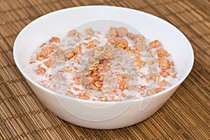 Muesli with dried fruits drenched in milk in bowl