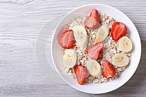 Muesli with fresh strawberries and banana horizontal top view