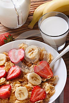 Muesli with fresh strawberries and banana vertical top view