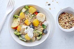 Muesli with fruits served in bowl