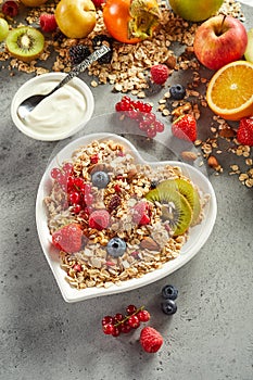Muesli with fruits and yogurt on table