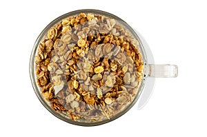 Muesli in glass cup isolated on white. Top view