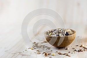 Muesli and granola in blurred wooden background. (Shallow aperture intended for the aesthetic quality of the blur)