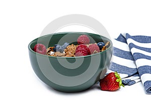 Muesli, isolate on white. Breakfast, healthy food and diet. Muesli with fruits and milk in a plate. Blueberries
