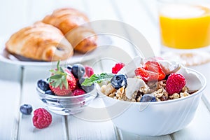 Muesli with yogurt and berries on a wooden table. Healthy fruit and cereal brakfast