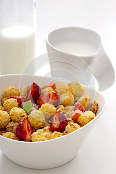 Mueslis with strawberry in a white cup on the white table for healthy breakfast