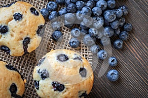 muffin with blueberries on a wooden table. fresh berries and sweet pastries on the board.