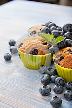 muffin with blueberries on a wooden table. fresh berries and sweet pastries on the board.