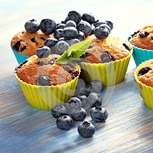 muffin with blueberries on a wooden table. fresh berries and sweet pastries on the board.