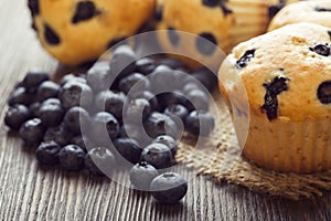 Muffin with blueberries on a wooden table. fresh berries and sweet pastries on the board