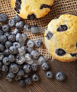 Muffin with blueberries on a wooden table. fresh berries and sweet pastries on the board