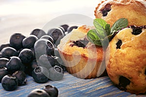 Muffin with blueberries on a wooden table. fresh berries and sweet pastries on the board