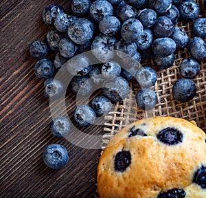 Muffin with blueberries on a wooden table. fresh berries and sweet pastries on the board