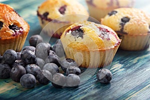 muffin with blueberries on a wooden table. fresh berries and sweet pastries on the board.