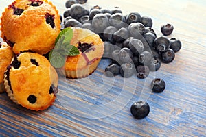 muffin with blueberries on a wooden table. fresh berries and sweet pastries on the board.