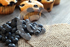 muffin with blueberries on a wooden table. fresh berries and sweet pastries on the board.