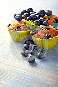 muffin with blueberries on a wooden table. fresh berries and sweet pastries on the board.