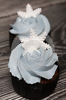 Muffin with cream cheese cream. Decorated with a marshmallow snowflake